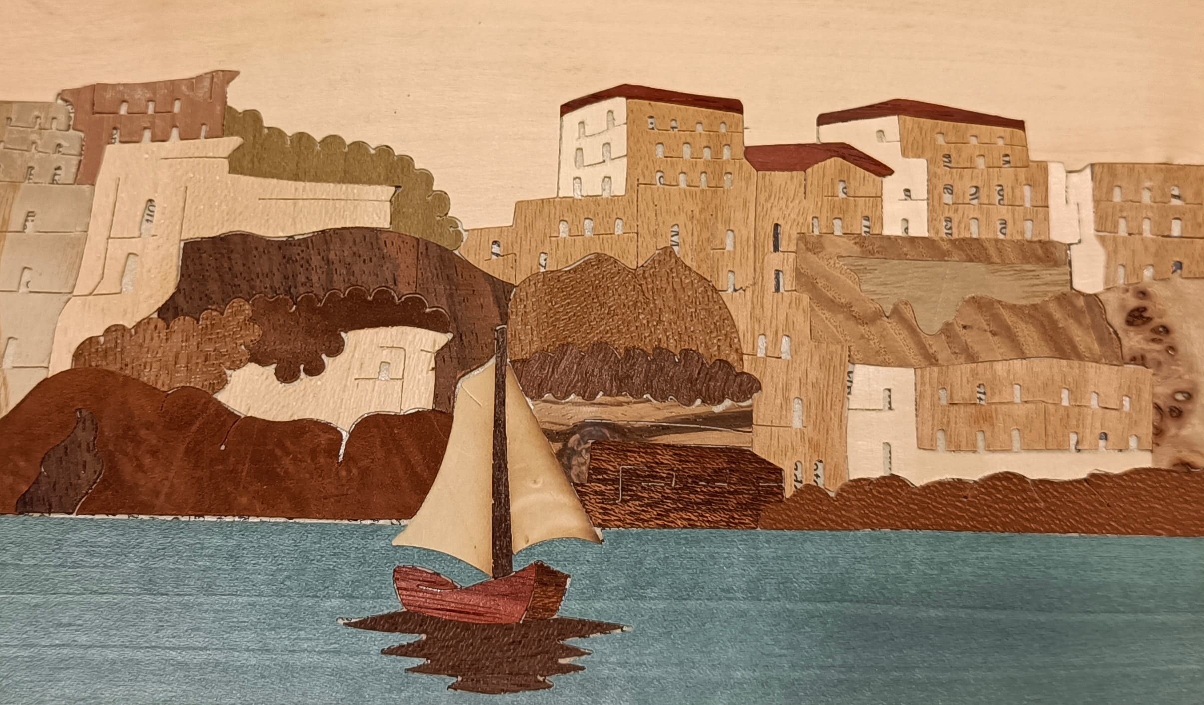 Close-up of a finished coastal-scene lid